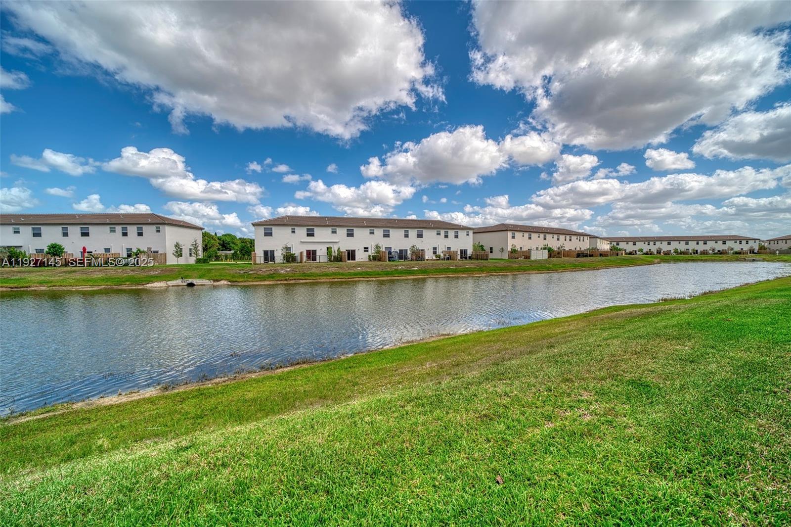 12661 Northwest 23rd Place Miami, FL 33167 - Photo 4 of 34 a view of a lake with a city in the background