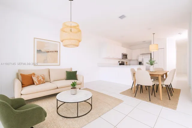 a living room with furniture and a dining table