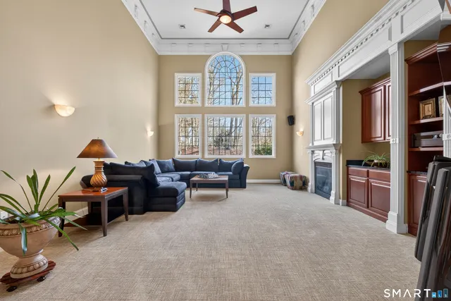 a living room with furniture and a floor to ceiling window