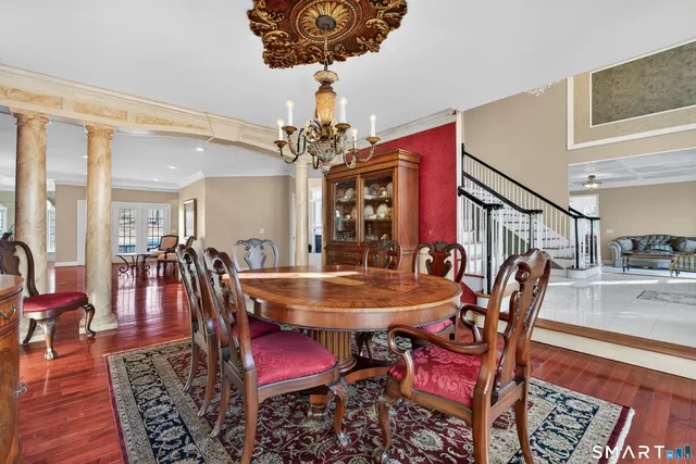 a view of staircase with lots of frames and frames on wall