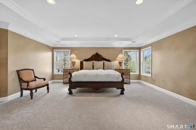 a bedroom with a bed and a ceiling fan