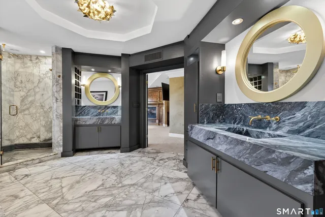 a bathroom with a granite countertop sink and a bathtub