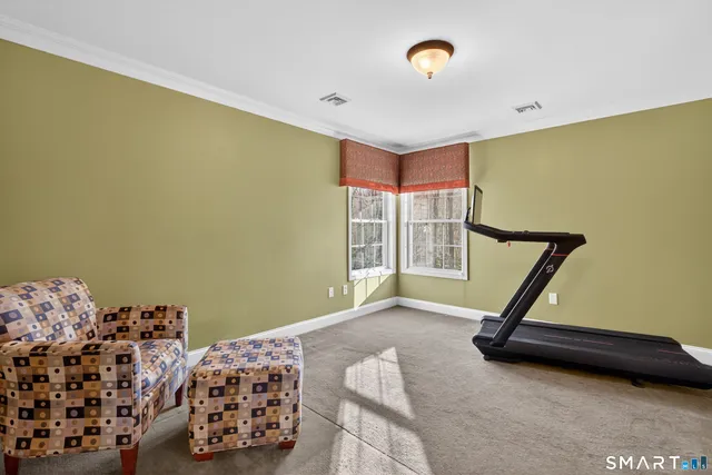 a room with gym equipment and windows