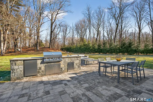 a front view of a house with a yard table and chairs