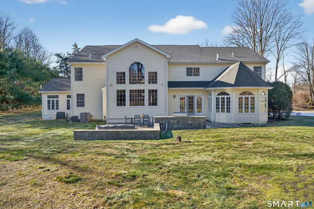 a view of a house with a yard and sitting area
