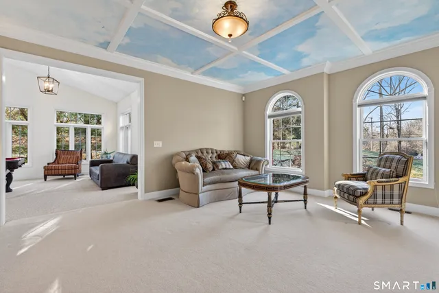 a living room with furniture a couch and a chandelier
