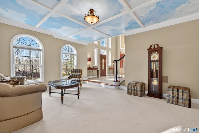 a living room with furniture a window and a table