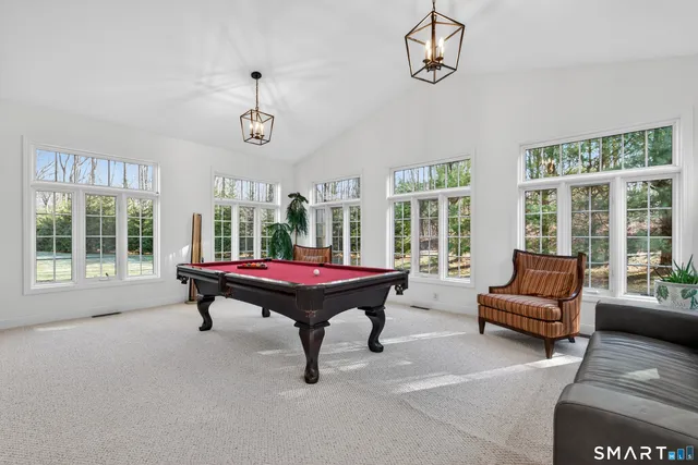 a living room with furniture a flat screen tv and a large window