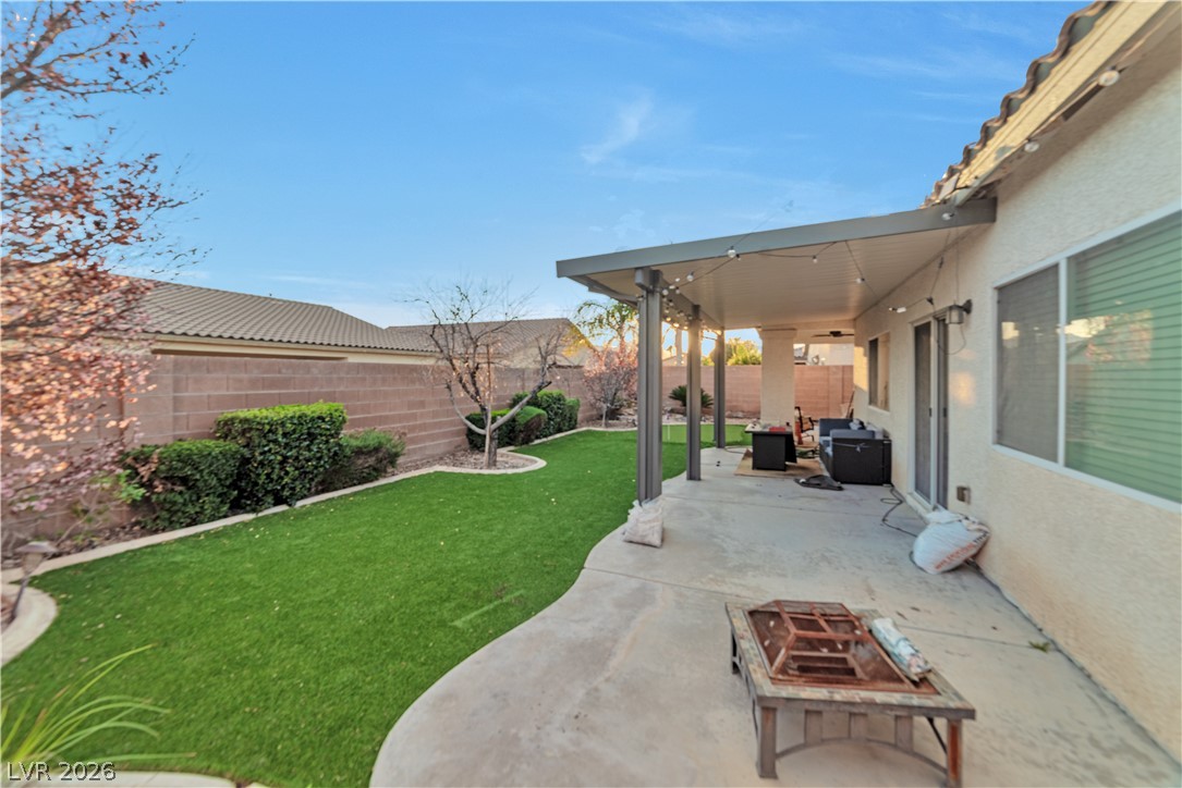 5915 Karnes Ranch Avenue Las Vegas, NV 89131 - Photo 11 of 28 Fenced backyard with a patio area