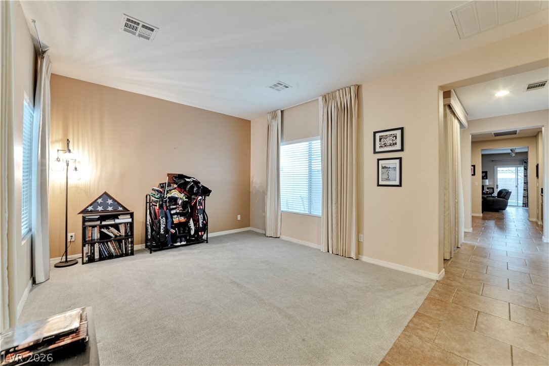 5915 Karnes Ranch Avenue Las Vegas, NV 89131 - Photo 13 of 28 Exercise room featuring light colored carpet and light tile patterned floors