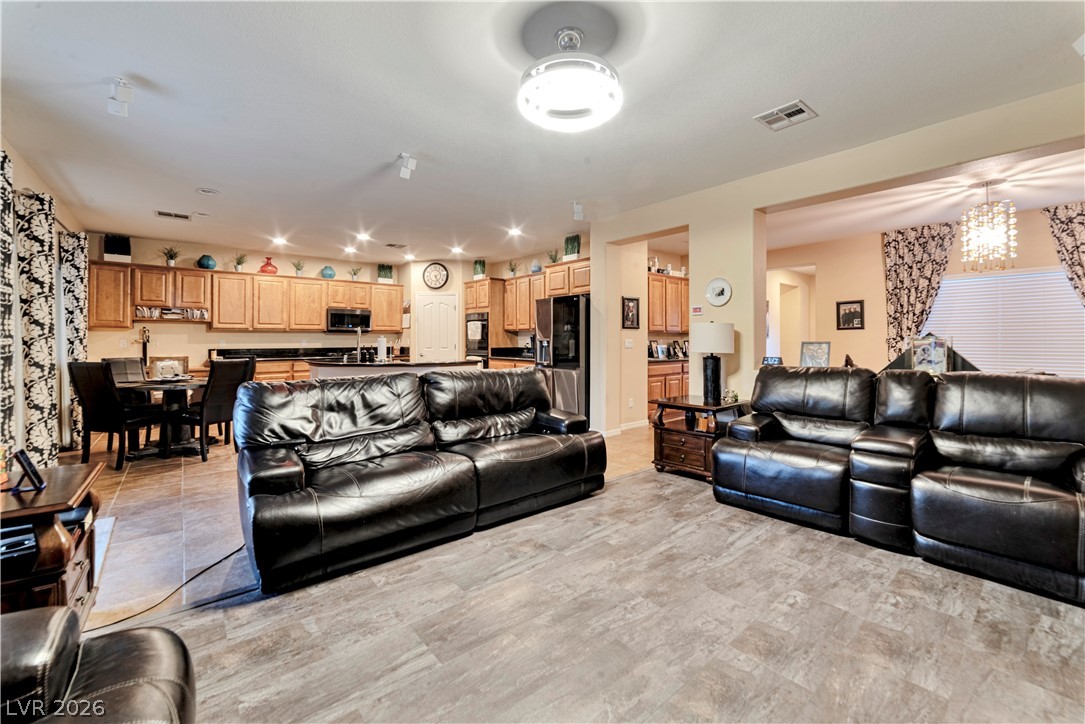 5915 Karnes Ranch Avenue Las Vegas, NV 89131 - Photo 17 of 28 Living room with suspended lighting