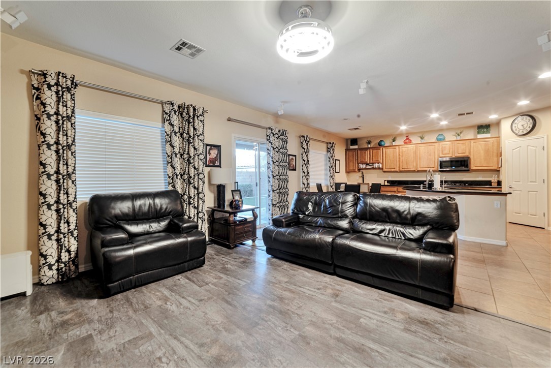 5915 Karnes Ranch Avenue Las Vegas, NV 89131 - Photo 18 of 28 Living room featuring recessed lighting and light tile patterned floors