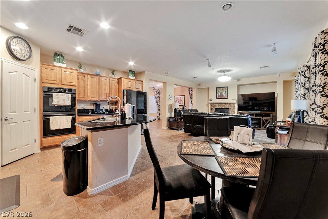 5915 Karnes Ranch Avenue Las Vegas, NV 89131 - Photo 21 of 28 Dining area with a fireplace and recessed lighting