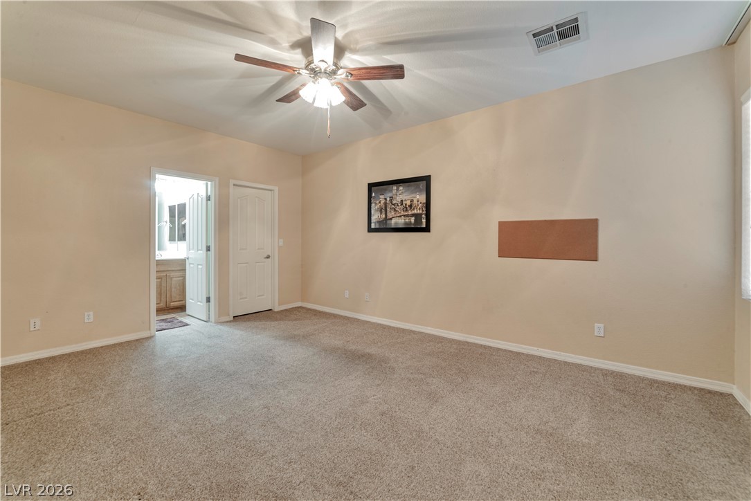 5915 Karnes Ranch Avenue Las Vegas, NV 89131 - Photo 22 of 28 Empty room featuring light carpet and a ceiling fan