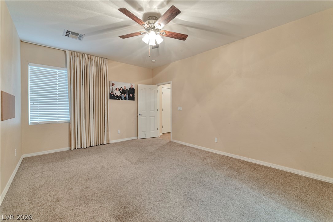 5915 Karnes Ranch Avenue Las Vegas, NV 89131 - Photo 23 of 28 Unfurnished room featuring ceiling fan and carpet flooring