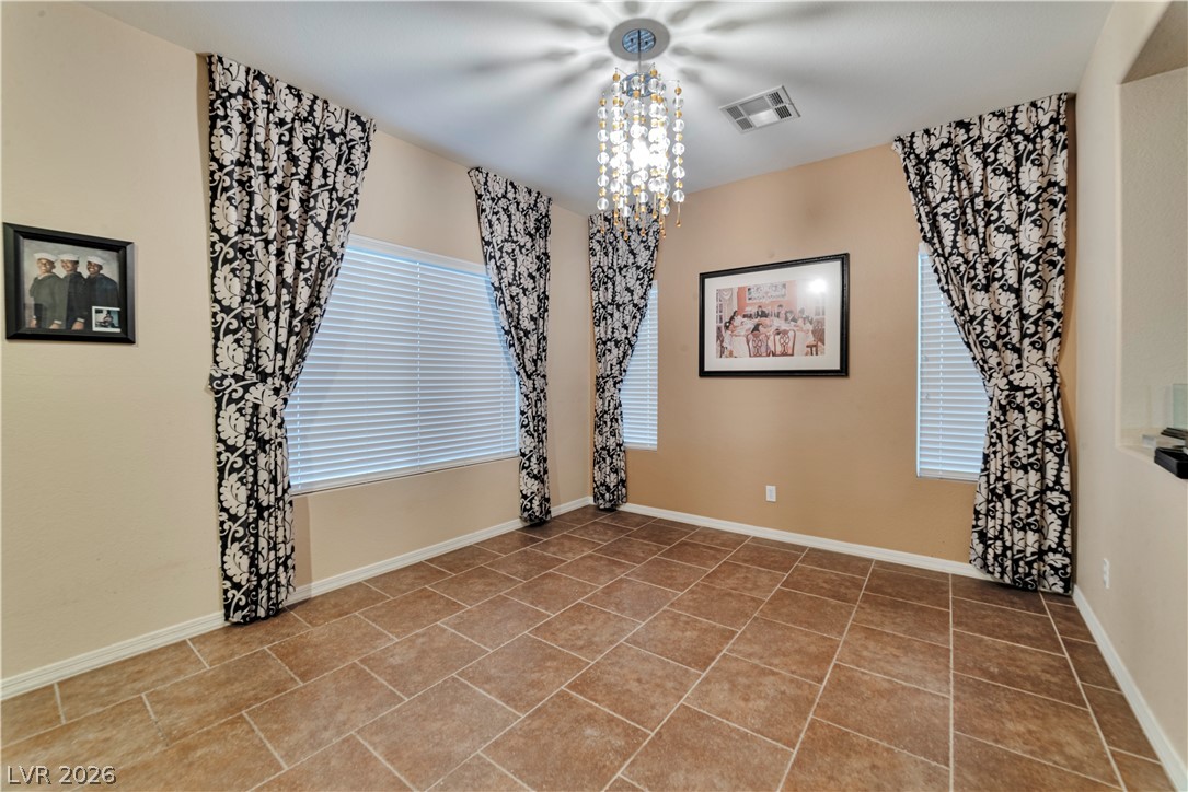 5915 Karnes Ranch Avenue Las Vegas, NV 89131 - Photo 26 of 28 Spare room featuring hanging lights and light tile patterned flooring