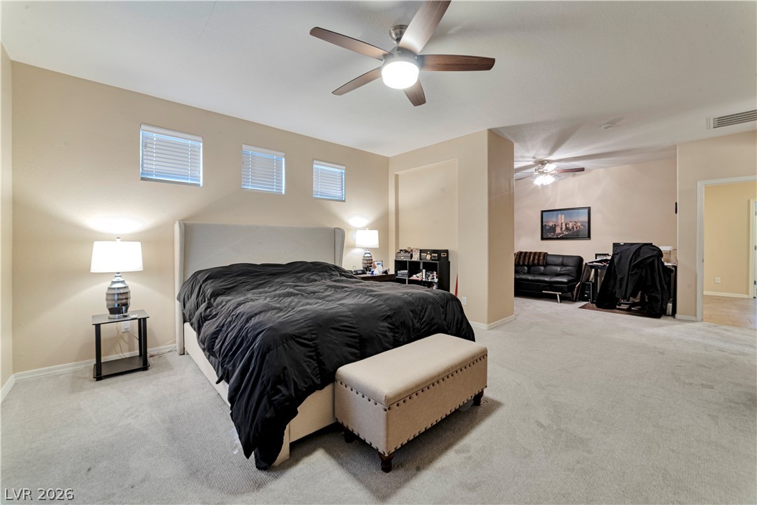 5915 Karnes Ranch Avenue Las Vegas, NV 89131 - Photo 3 of 28 Bedroom featuring light carpet and a ceiling fan