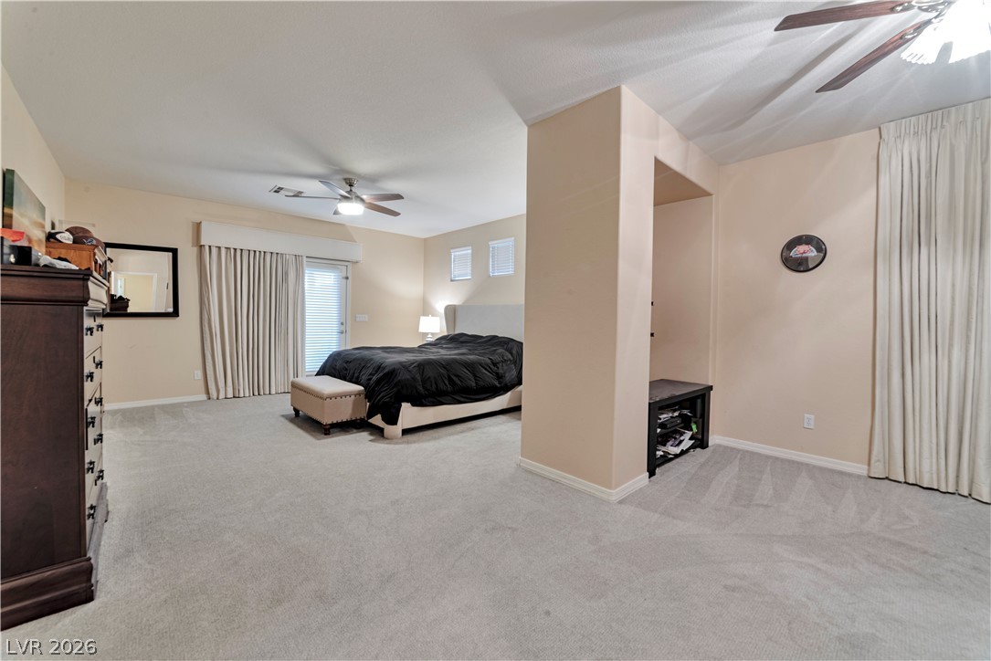 5915 Karnes Ranch Avenue Las Vegas, NV 89131 - Photo 4 of 28 Bedroom with a ceiling fan and light colored carpet