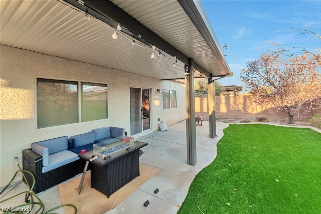 5915 Karnes Ranch Avenue Las Vegas, NV 89131 - Photo 6 of 28 Fenced backyard with a patio and outdoor lounge area