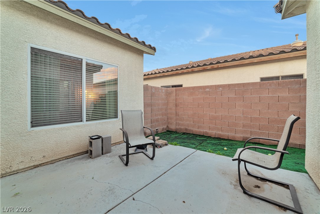 5915 Karnes Ranch Avenue Las Vegas, NV 89131 - Photo 8 of 28 Fenced backyard with a patio area