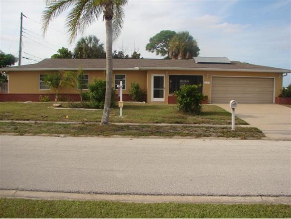 3197 Northeast Eastman Palm Bay, FL 32905 - Photo 1 of 11 a front view of a house with garden and porch