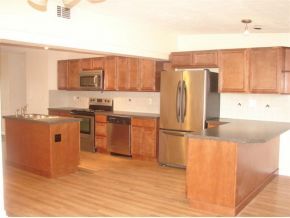 3197 Northeast Eastman Palm Bay, FL 32905 - Photo 3 of 11 a kitchen with stainless steel appliances granite countertop a refrigerator a stove and a sink