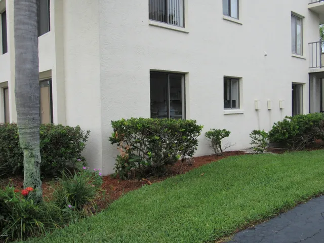 a front view of house with a garden
