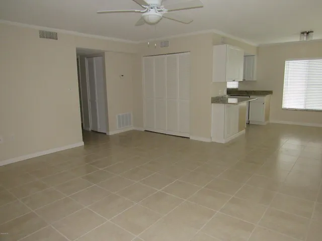 an empty room with windows and entrance