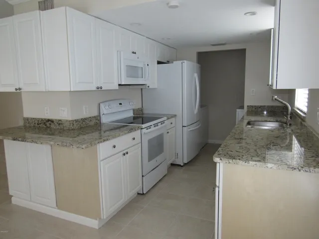 a kitchen with a sink stove and refrigerator