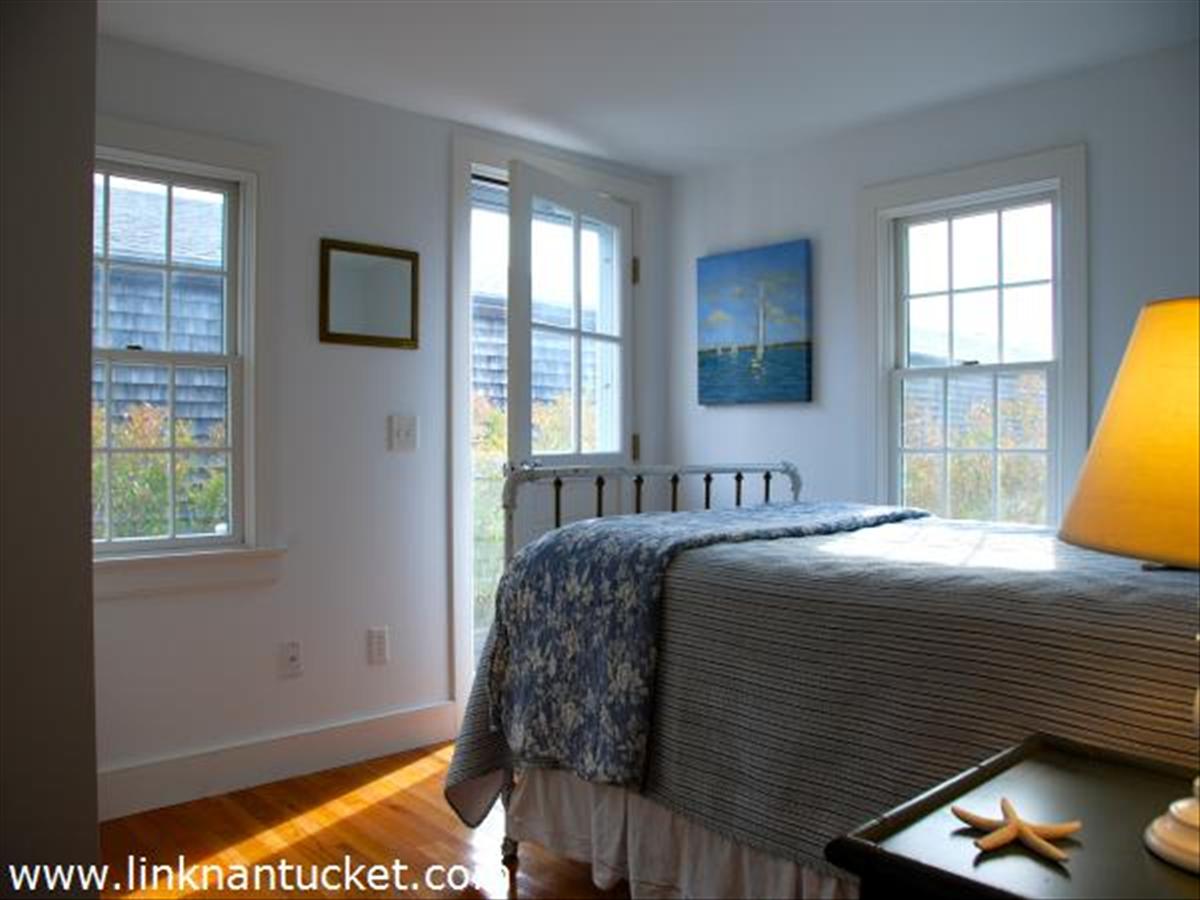 3 D Sun Island Road, Unit 1 Nantucket, MA 02554 - Photo 5 of 14 a bedroom with a bed and a window