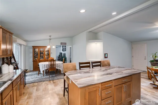 a kitchen with stainless steel appliances granite countertop a refrigerator and a stove top oven