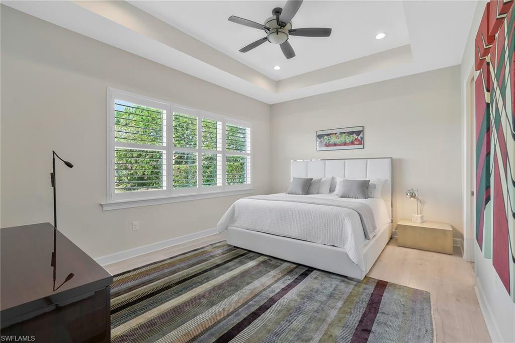 5167 Andros Drive Naples, FL 34113 - Photo 12 of 32 a bedroom with a bed and a window