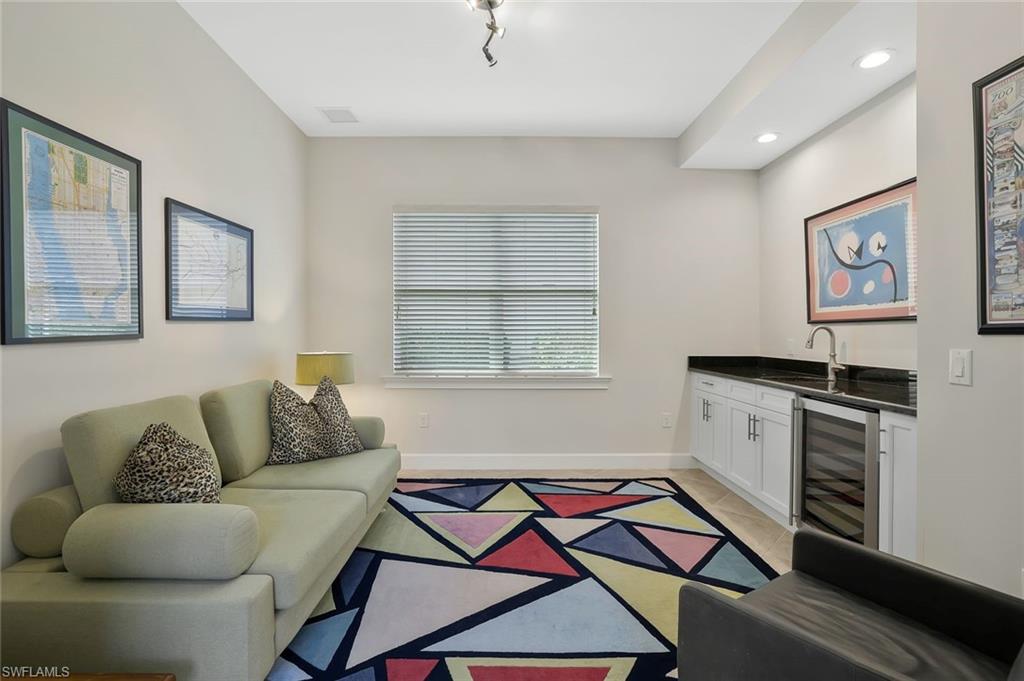 5167 Andros Drive Naples, FL 34113 - Photo 18 of 32 a living room with furniture and a stove