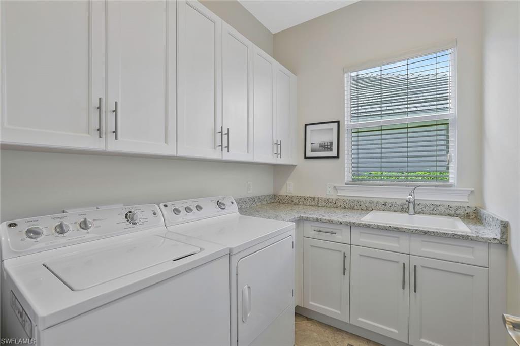 5167 Andros Drive Naples, FL 34113 - Photo 19 of 32 a utility room with cabinets washer and dryer