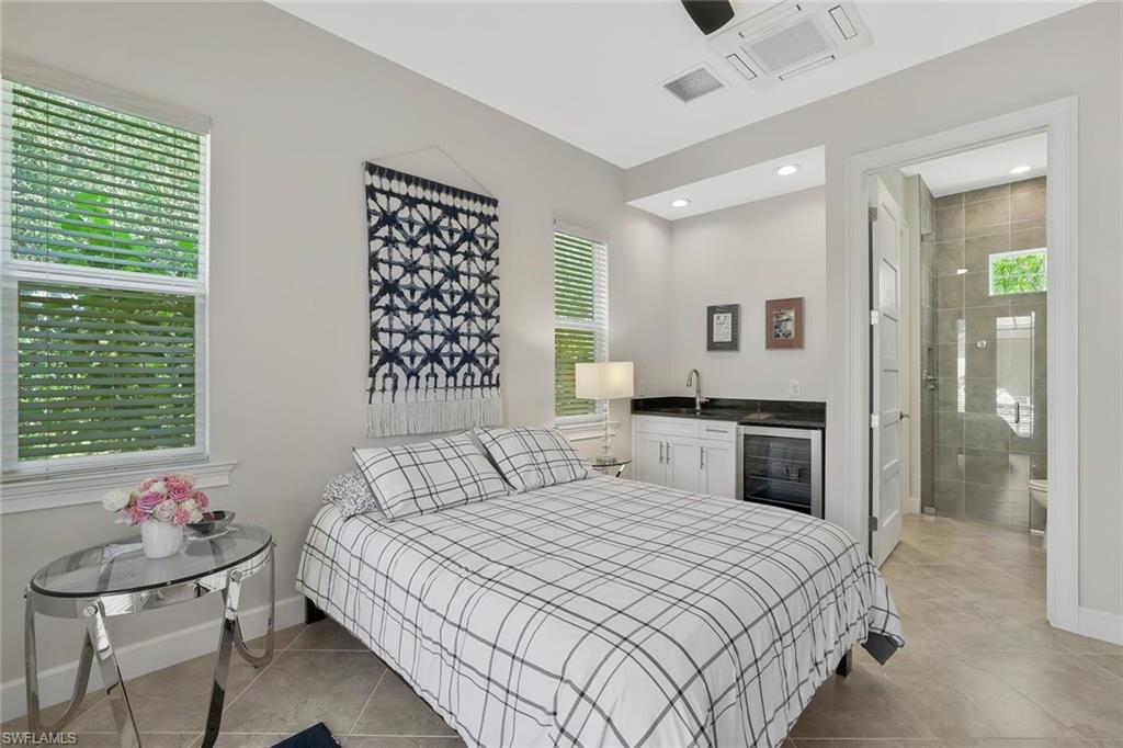 5167 Andros Drive Naples, FL 34113 - Photo 20 of 32 a bedroom with a bed and a window