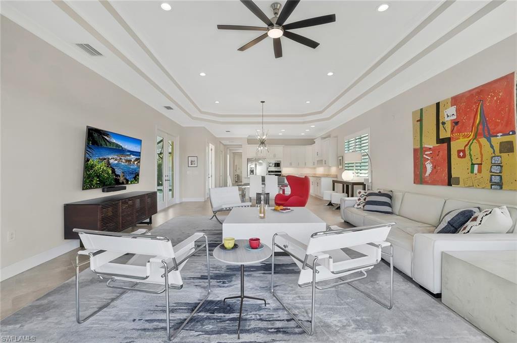 5167 Andros Drive Naples, FL 34113 - Photo 2 of 32 a living room with furniture and a flat screen tv