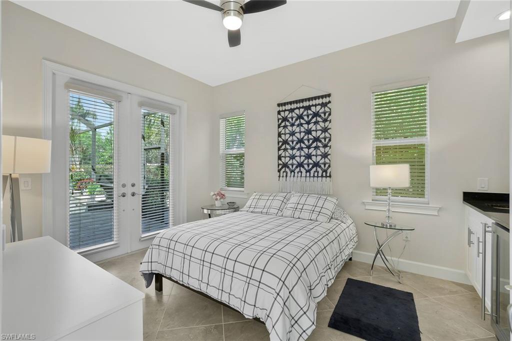 5167 Andros Drive Naples, FL 34113 - Photo 21 of 32 a bedroom with a bed and a window
