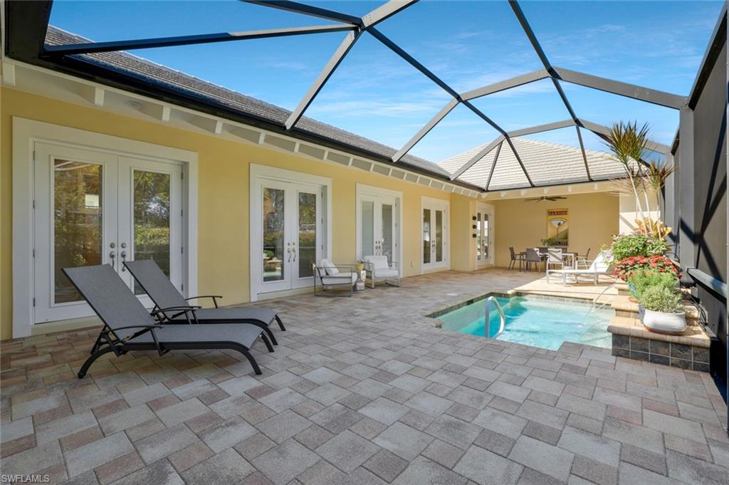 5167 Andros Drive Naples, FL 34113 - Photo 28 of 32 a view of a patio with table and chairs