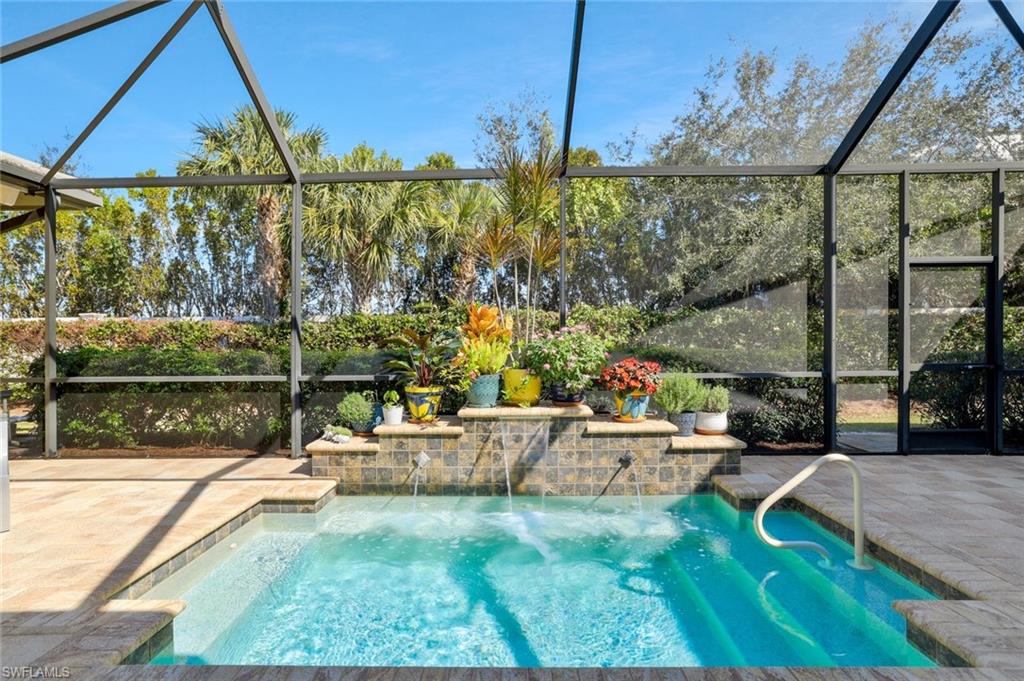 5167 Andros Drive Naples, FL 34113 - Photo 3 of 32 a view of swimming pool with a patio and a yard