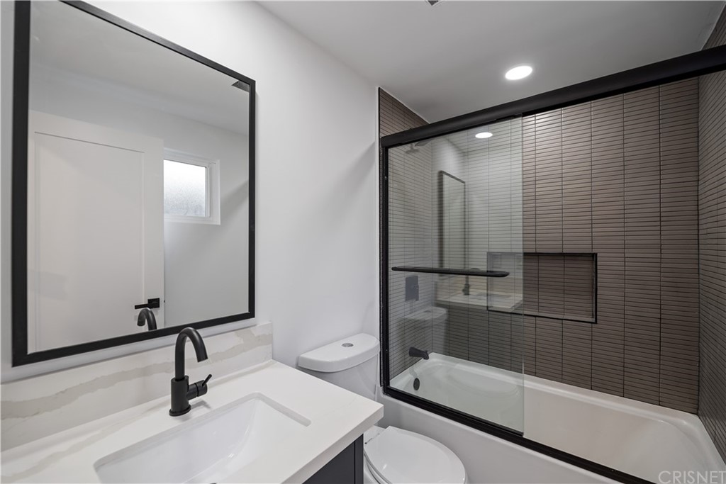 13151 Morrison Street Sherman Oaks, CA 91423 - Photo 15 of 26 a bathroom with a sink a toilet and a large mirror