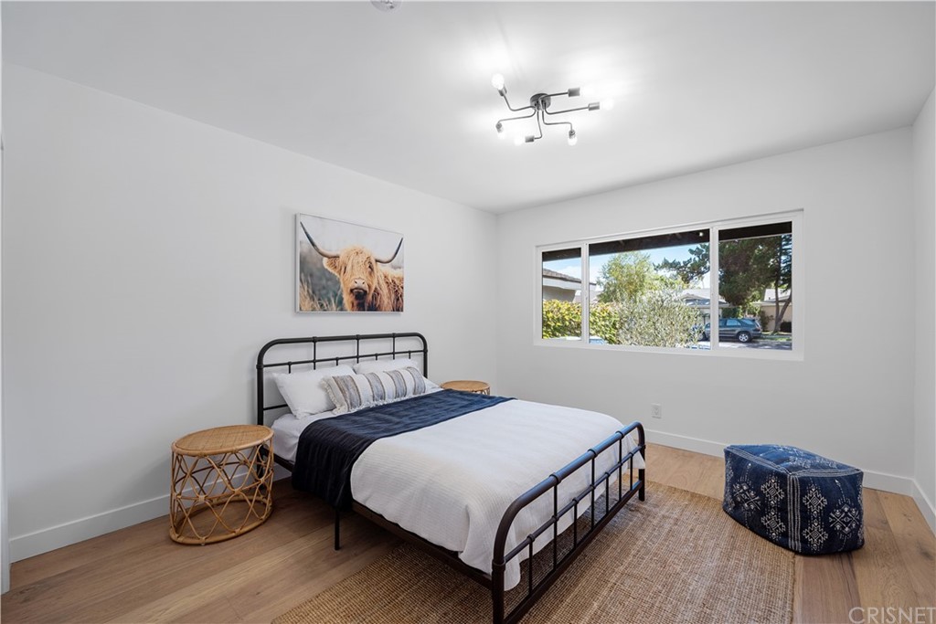 13151 Morrison Street Sherman Oaks, CA 91423 - Photo 16 of 26 a bedroom with a bed and lamp