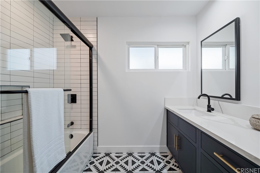 13151 Morrison Street Sherman Oaks, CA 91423 - Photo 18 of 26 a bathroom with a sink a mirror and a shower