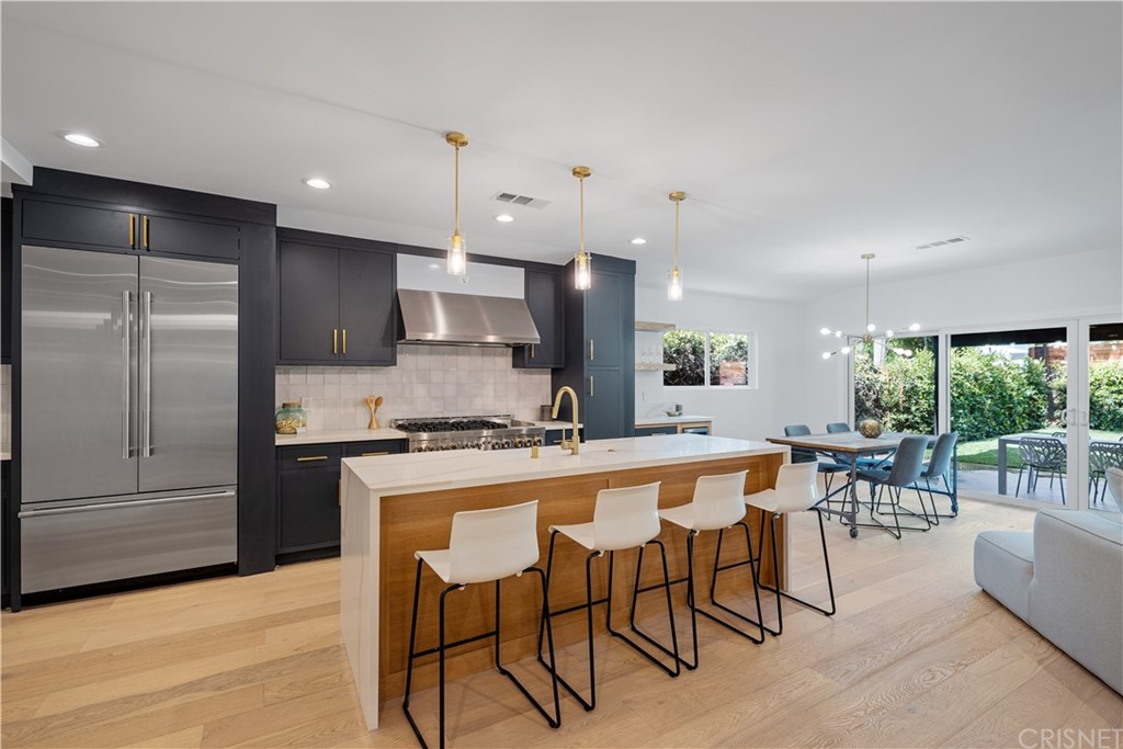 13151 Morrison Street Sherman Oaks, CA 91423 - Photo 3 of 26 a large kitchen with a table and chairs