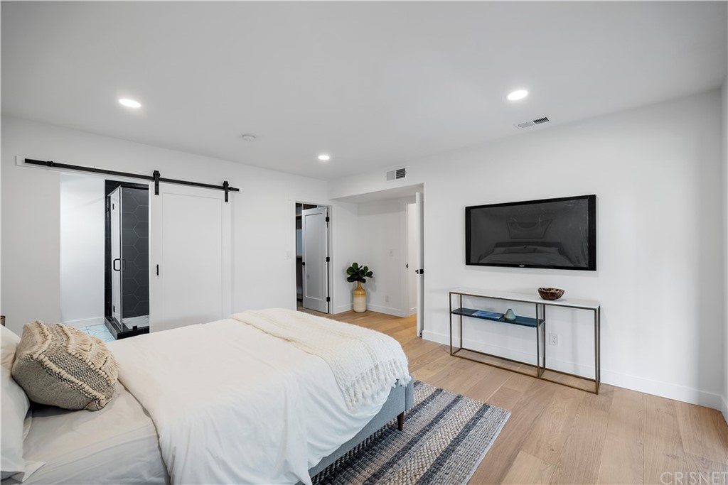 13151 Morrison Street Sherman Oaks, CA 91423 - Photo 21 of 26 a bedroom with a bed and a flat screen tv