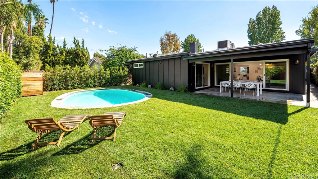 13151 Morrison Street Sherman Oaks, CA 91423 - Photo 26 of 26 a view of a backyard with table and chairs with wooden fence and plants
