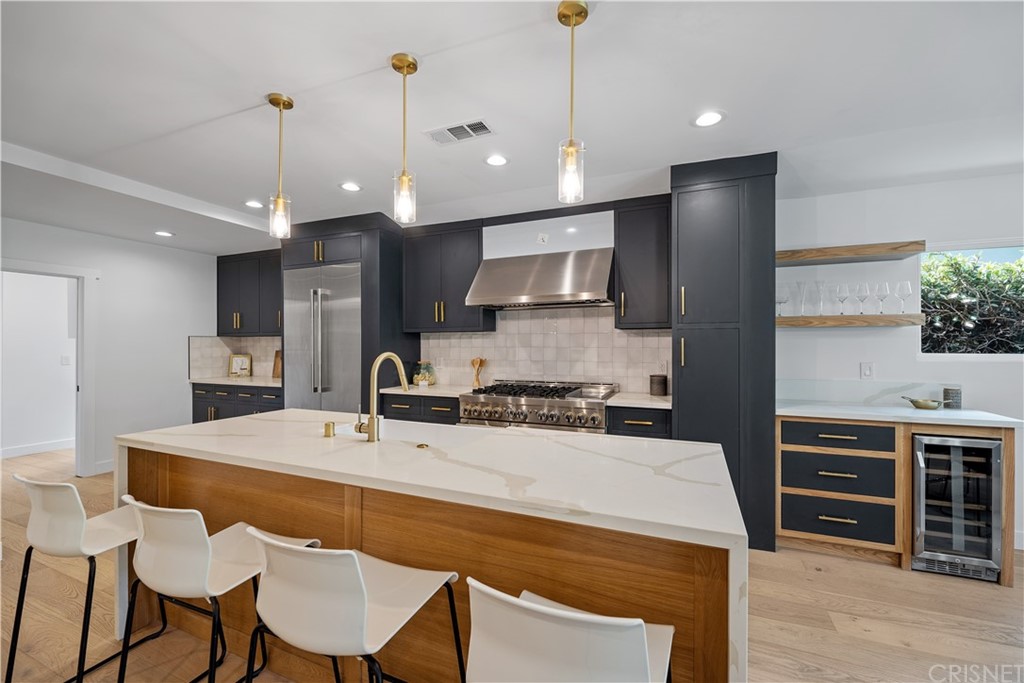 13151 Morrison Street Sherman Oaks, CA 91423 - Photo 4 of 26 a kitchen with a dining table chairs sink and cabinets