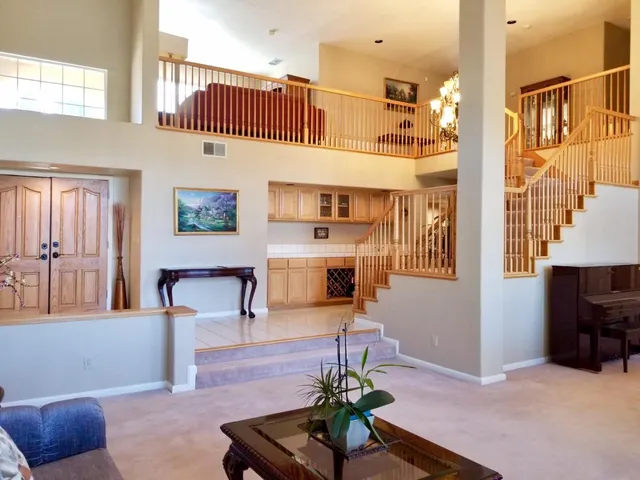 a living room with furniture and a potted plant