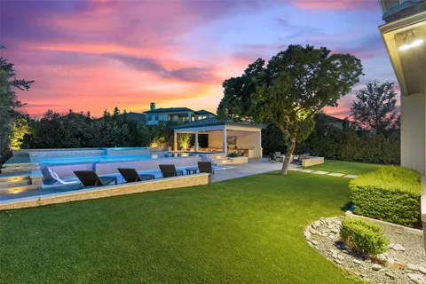 a view of a house with backyard porch and sitting area