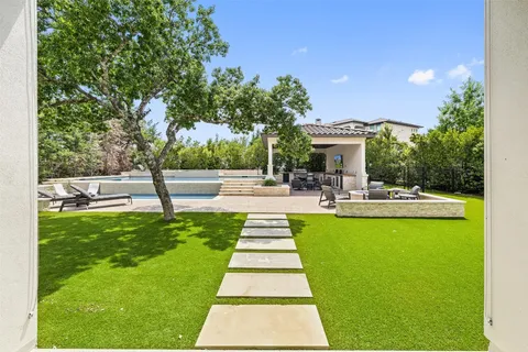 a view of a house with swimming pool and porch