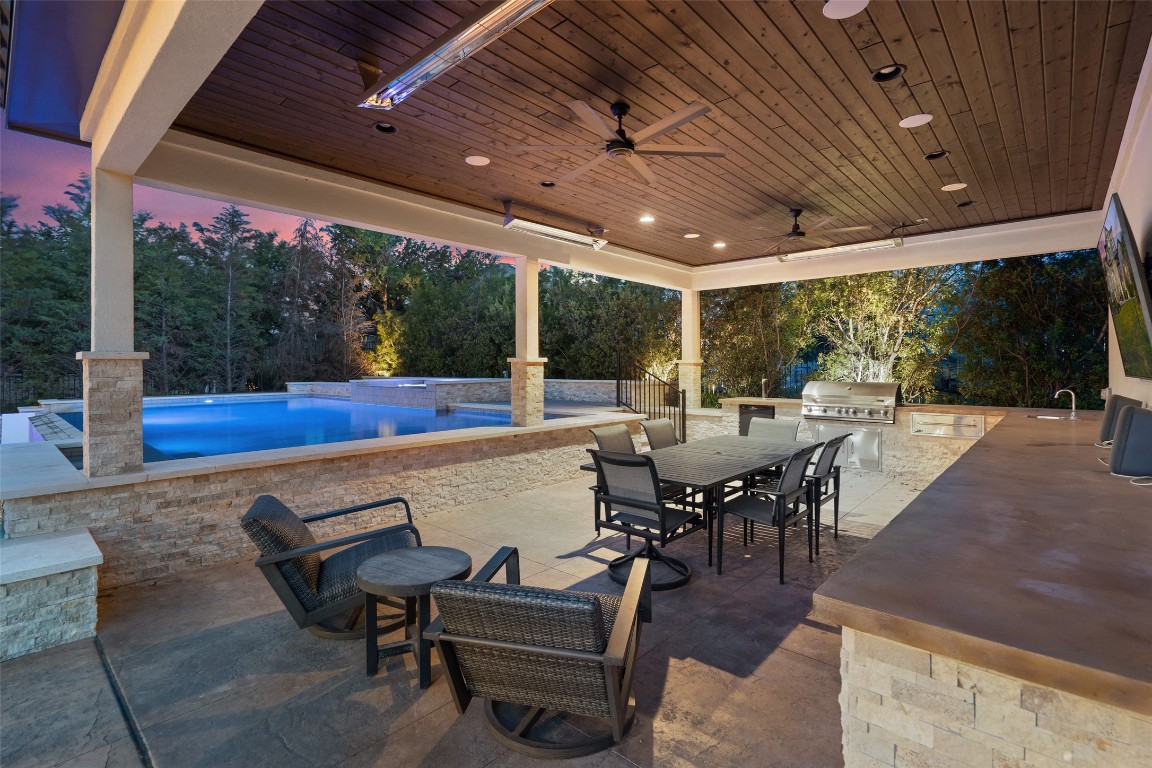 403 Woodside Terrace Austin, TX 78738 - Photo 19 of 38 View of patio / terrace featuring area for grilling, an outdoor pool, outdoor dining space, a ceiling fan, and a jacuzzi